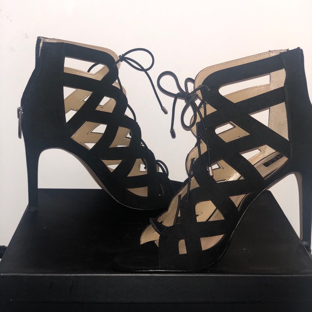 Back zipper, lace-up detail, silvertone hardware, Suede
4"Heel
Fit: true to size